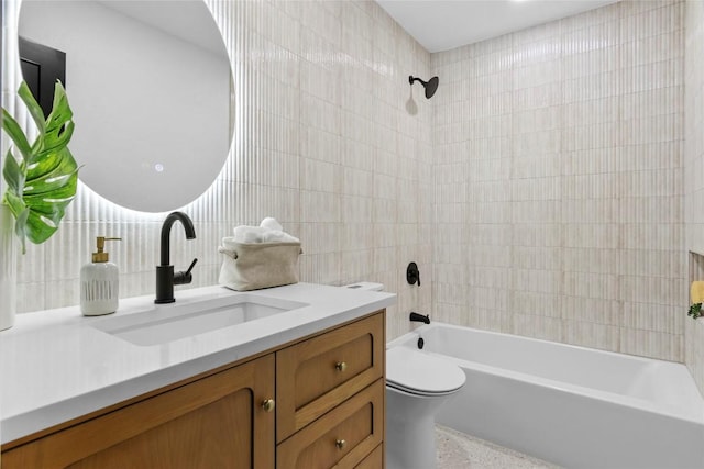 full bathroom with vanity, shower / bath combination, toilet, and tile walls