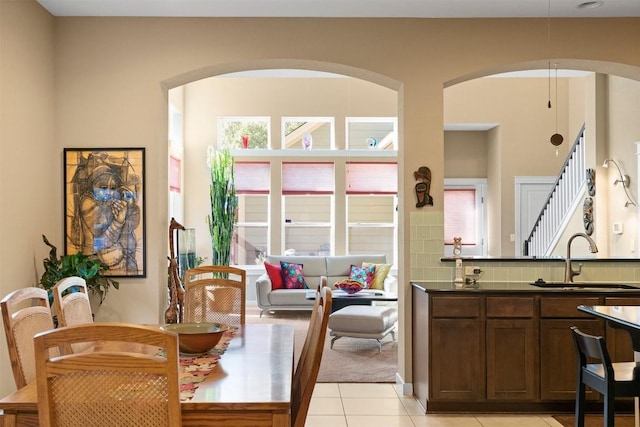 dining space featuring sink and light tile patterned flooring