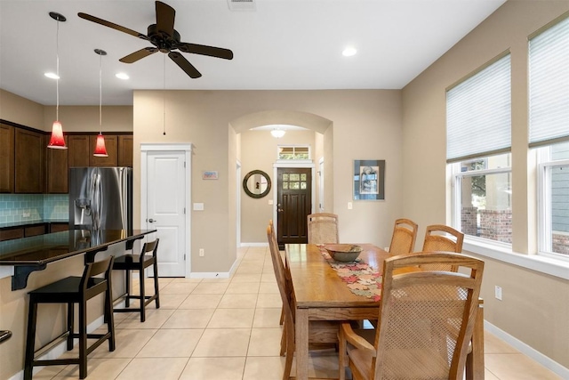 tiled dining area with ceiling fan