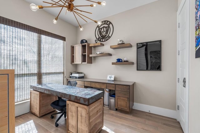 11600 Shoreview Overlook, Austin, TX 78732 - office area with light wood finished floors, built in study area, and a chandelier