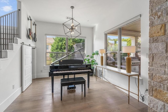 11600 Shoreview Overlook, Austin, TX 78732 - living area featuring wood finished floors, a barn door, and a chandelier