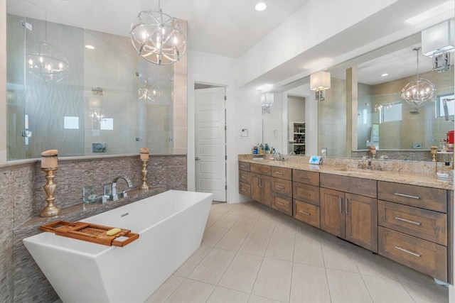 11600 Shoreview Overlook, Austin, TX 78732 - full bath featuring a chandelier, tile patterned flooring, a stall shower, and a freestanding tub