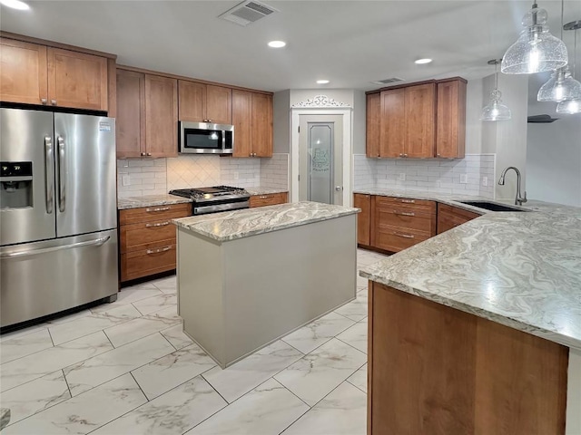 kitchen with sink, hanging light fixtures, light stone countertops, kitchen peninsula, and stainless steel appliances