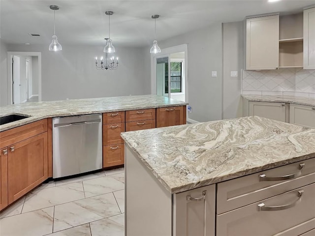 kitchen featuring stainless steel dishwasher, a center island, and light stone countertops