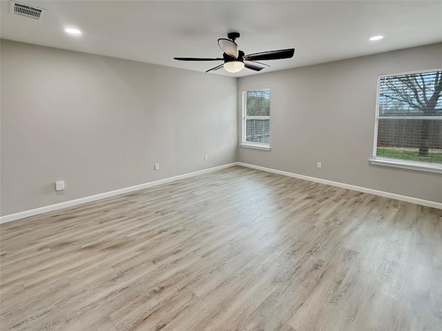 unfurnished room featuring light hardwood / wood-style floors, plenty of natural light, and ceiling fan