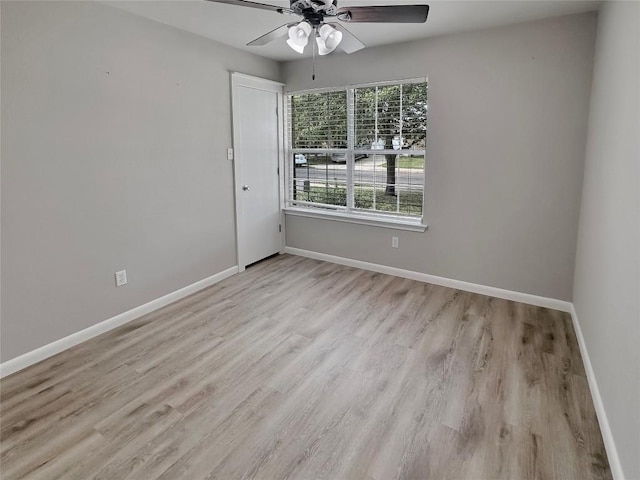 spare room with light wood-type flooring and ceiling fan