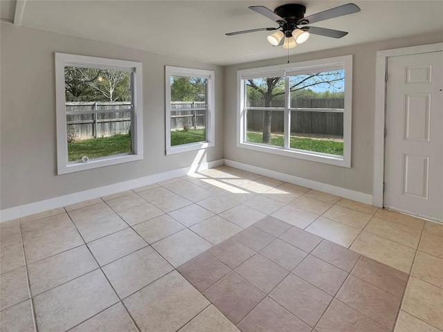 tiled spare room with ceiling fan