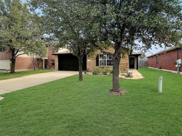 view of front of property with a garage and a front lawn