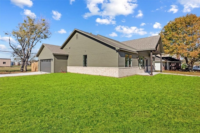 view of home's exterior with a garage and a lawn