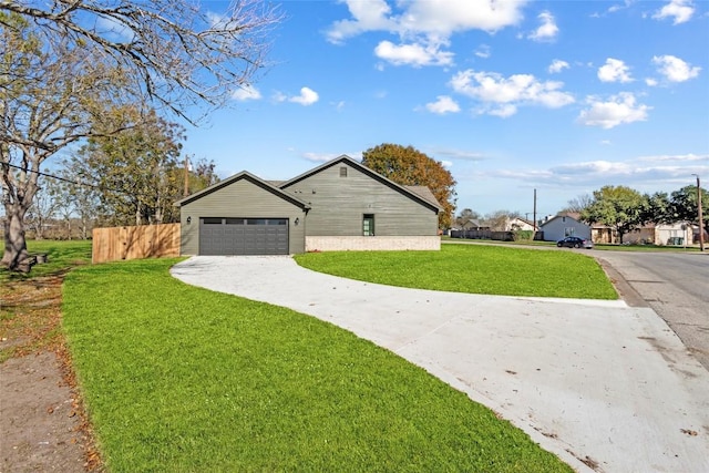 view of side of home featuring a yard and a garage