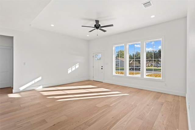 unfurnished living room featuring ceiling fan and light hardwood / wood-style flooring