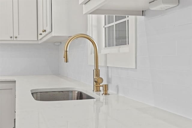 interior details with white cabinetry and sink