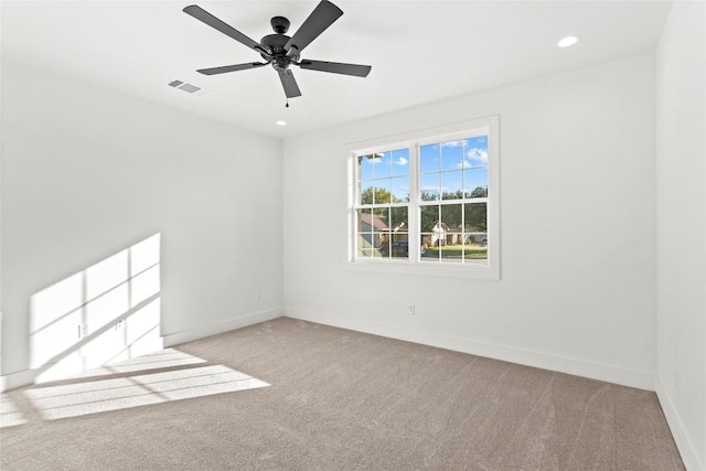 unfurnished room featuring light carpet and ceiling fan