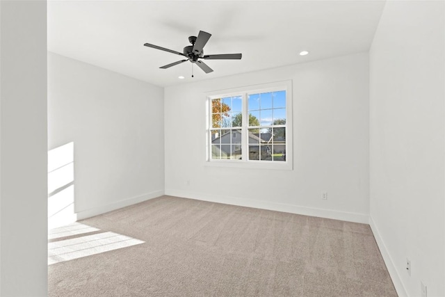 unfurnished room featuring light carpet and ceiling fan