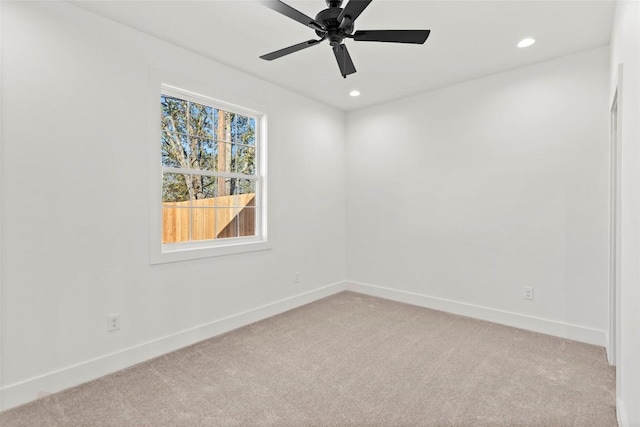 empty room featuring light colored carpet and ceiling fan