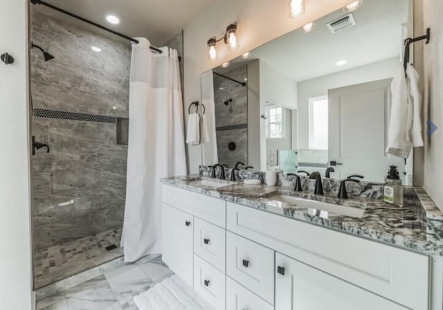 bathroom featuring vanity and curtained shower