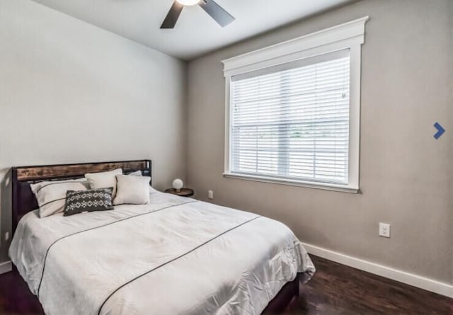 bedroom featuring multiple windows, ceiling fan, and dark wood-type flooring