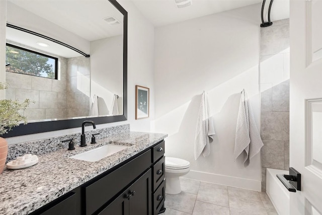 full bathroom featuring tile patterned floors, vanity, toilet, and tiled shower / bath combo