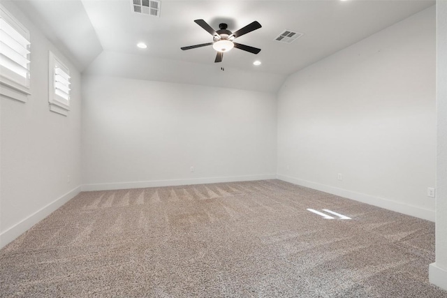 spare room with ceiling fan, carpet, and vaulted ceiling