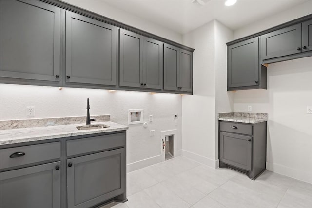 washroom with sink, cabinets, washer hookup, gas dryer hookup, and light tile patterned flooring