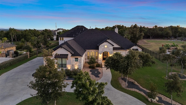 french provincial home featuring a yard