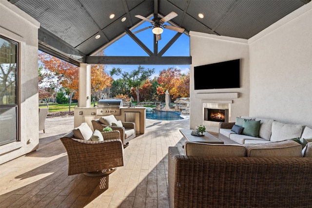 view of patio / terrace with an outdoor living space with a fireplace, an outdoor kitchen, and a grill