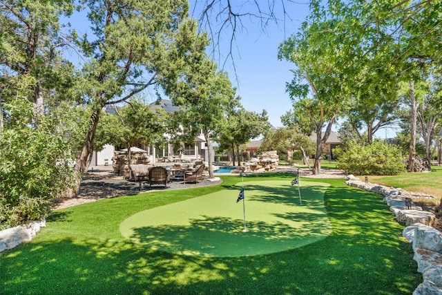 view of community featuring a yard and a patio