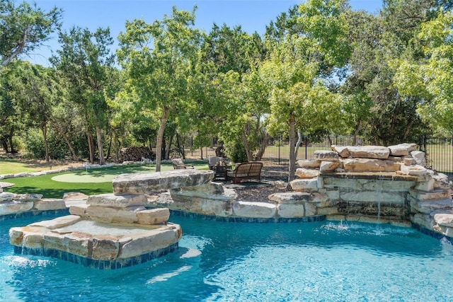 view of swimming pool with pool water feature