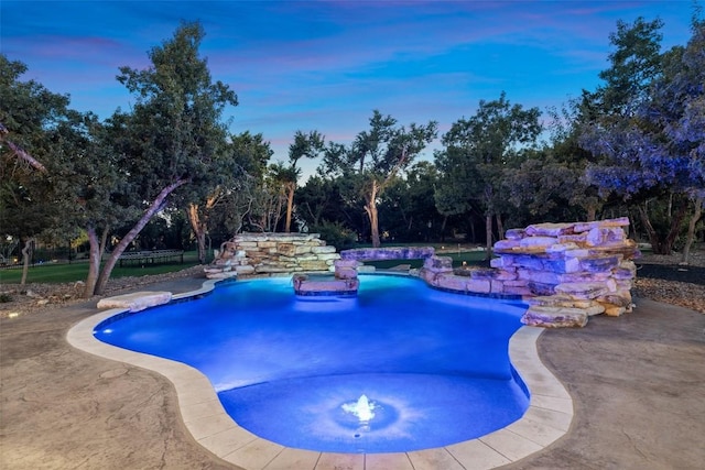 view of pool at dusk