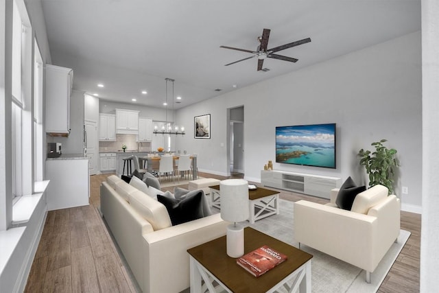 living room featuring light hardwood / wood-style flooring and ceiling fan