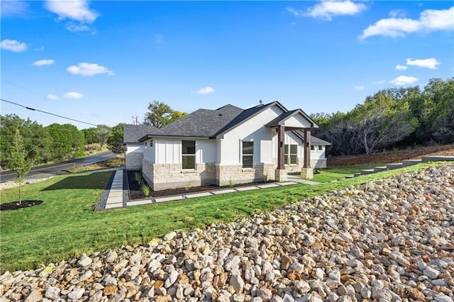 rear view of property featuring a lawn