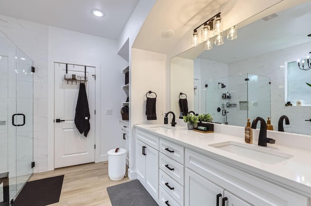 bathroom with vanity, hardwood / wood-style floors, and an enclosed shower