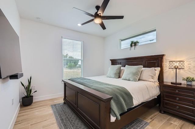 bedroom with ceiling fan and light hardwood / wood-style floors