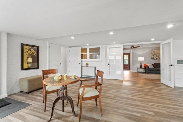 dining space featuring ceiling fan, french doors, and light hardwood / wood-style flooring