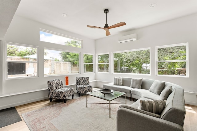 sunroom with an AC wall unit and ceiling fan