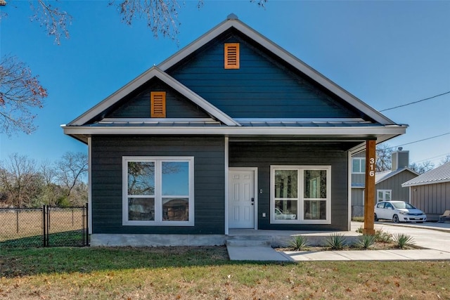 view of front of house featuring covered porch and a front lawn