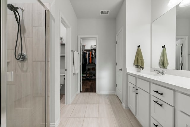 bathroom featuring vanity and a shower with shower door