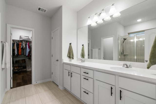 bathroom with vanity, tile patterned floors, and a shower with shower door