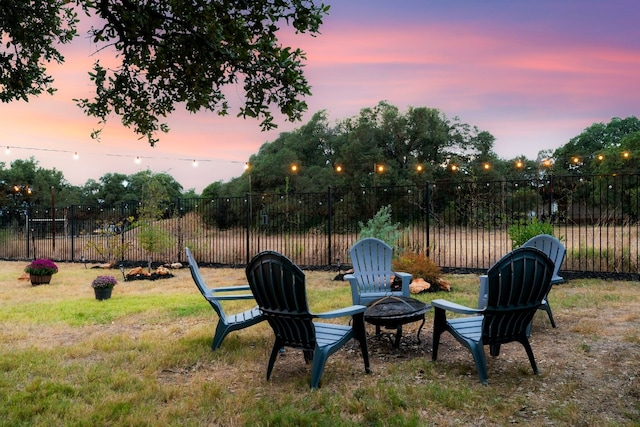 yard at dusk featuring a fire pit