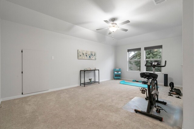 exercise area featuring ceiling fan and light carpet