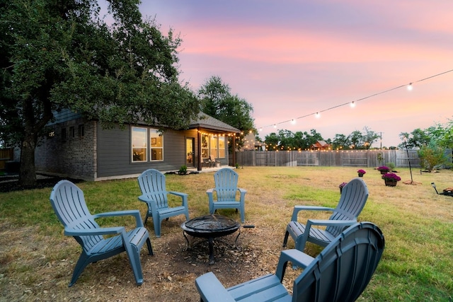 yard at dusk with an outdoor fire pit