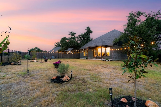 view of yard at dusk