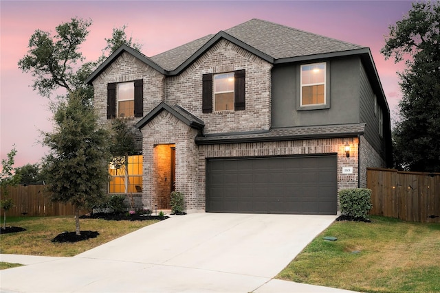 view of front facade featuring a lawn and a garage