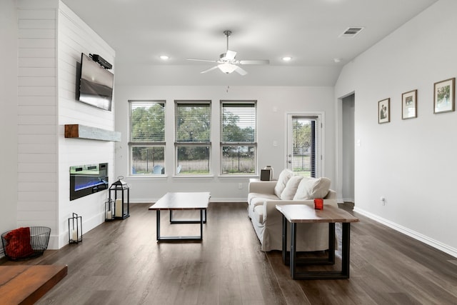 living room featuring a large fireplace, dark wood-type flooring, ceiling fan, and vaulted ceiling