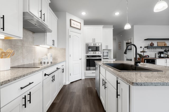 kitchen featuring sink, decorative light fixtures, white cabinetry, and appliances with stainless steel finishes