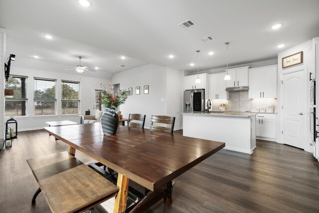 dining room with ceiling fan, dark hardwood / wood-style flooring, and sink