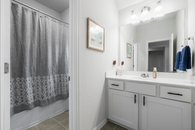 bathroom with tile patterned flooring and vanity