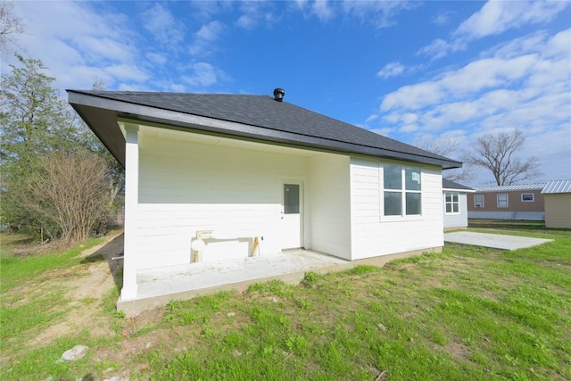 rear view of property with a yard and a patio