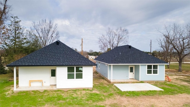 rear view of property with a lawn