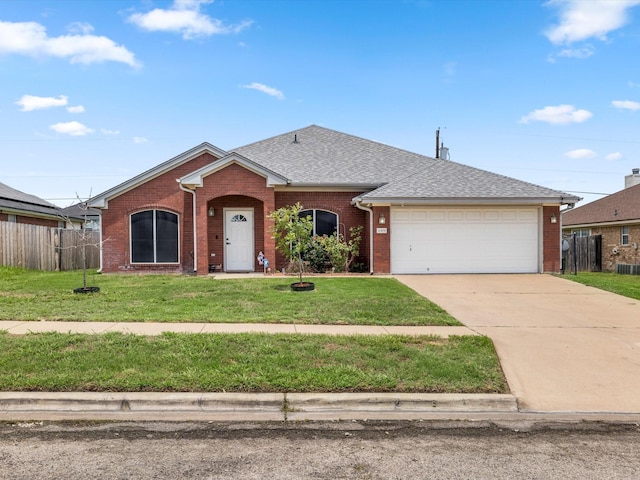 ranch-style house featuring a garage and a front lawn